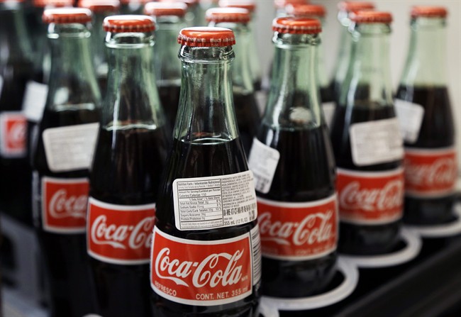 Bottles of Coca-Cola are on display at a supermarket.