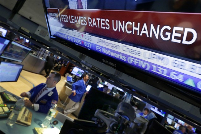 The U.S. Federal Reserve signaled Thursday it wants to see better global economic conditions and higher inflation before raising interest rates.
