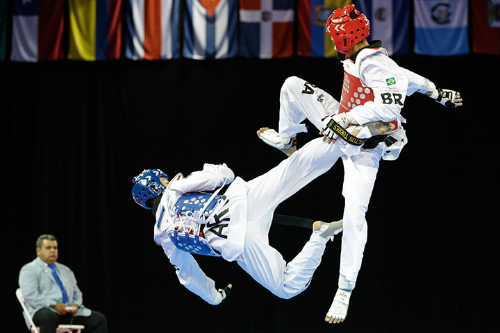 Argentina’s Lucas Guzman, left, fights against Brazil’s Venilton Torres during a men’s -58kg bronze medal taekwondo match at the Pan Am Games in Mississauga, Ontario on Sunday, July 19, 2015.