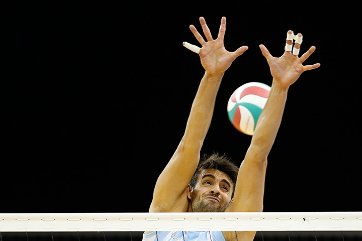 Argentina’s Sebastian Sole fails to block a spike by Canada’s Gavin Schmitt during a men’s volleyball semi-final match at the Pan Am Games in Toronto on Friday, July 24, 2015.