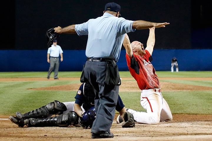 Canada’s Peter Orr, right, reacts after scoring the game-winning run under the tag of United States catcher Thomas Murphy’s in the 10th inning of the gold medal baseball game at the Pan Am Games in Ajax, Ontario, Sunday, July 19, 2015.