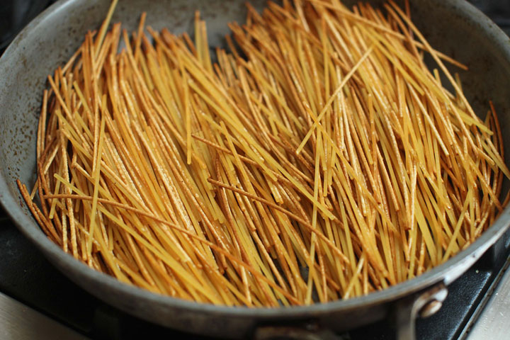 This June 22, 2015 photo shows the preparation of pasta for breakfast for dinner spaghetti in Concord, N.H. This dish is from a recipe by Sara Moulton.