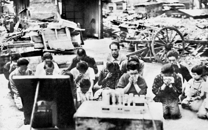 People kneel and listen to the radio in Tokyo, as Emperor Hirohito announced on radio that Japan was defeated in the Second World War on Aug. 15, 1945.