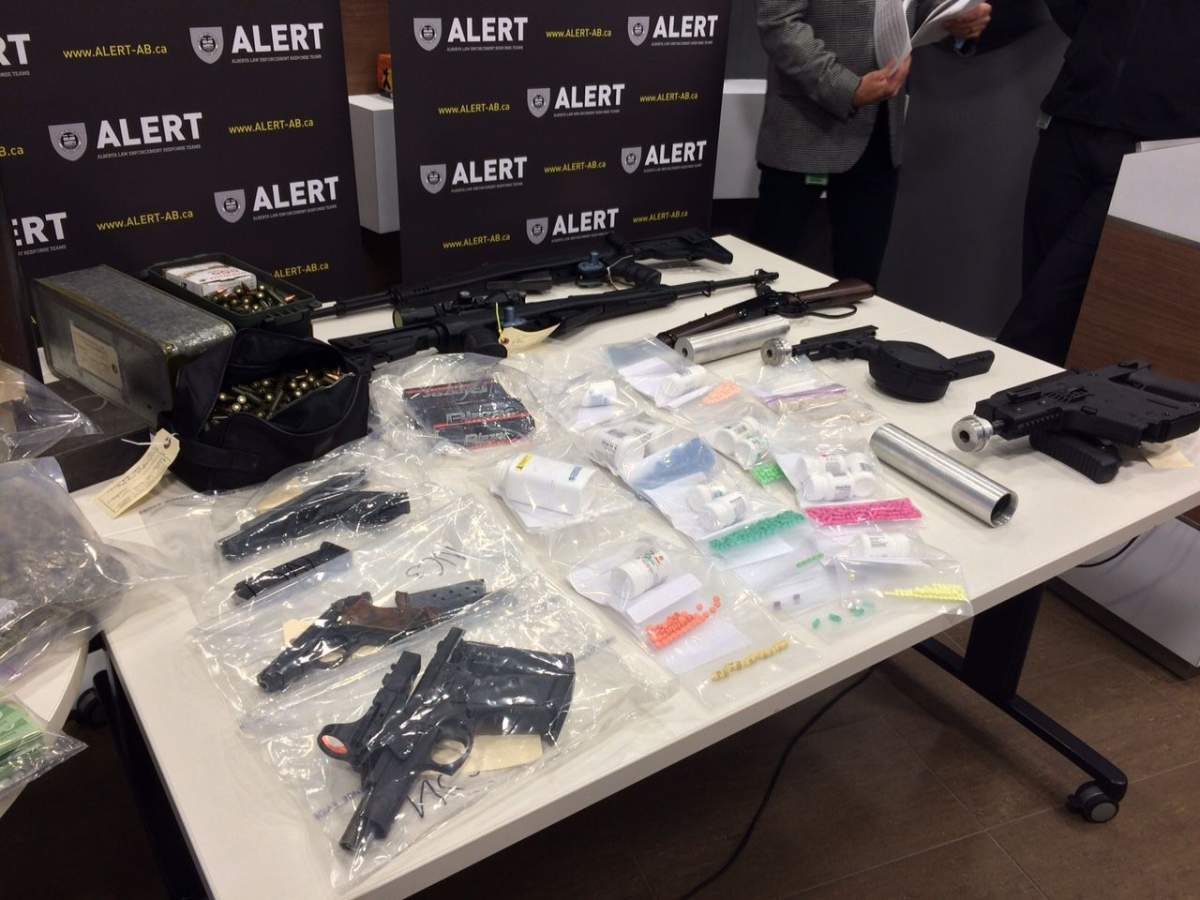 Four people were charged after an Alberta Law Enforcement Response Teams raid in north Edmonton uncovered eight high-powered firearms and more than $100,000 worth of drugs.