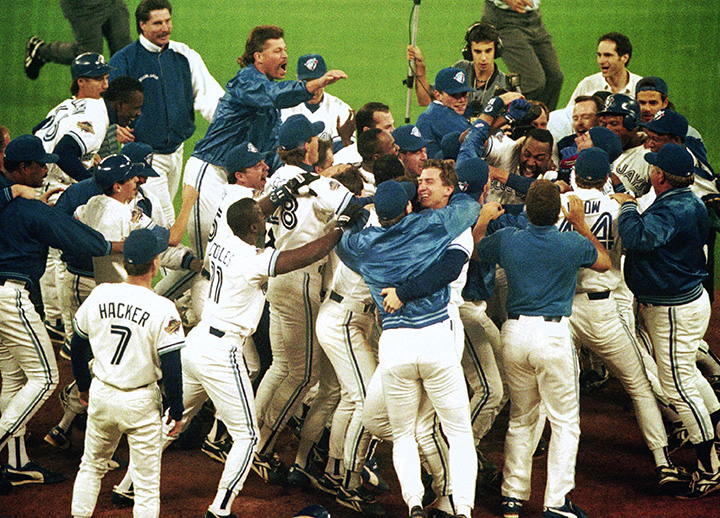 Toronto Blue Jays members mob teammate Joe Carter after his game winning home run in bottom of 9th in Game 6 of World Series, October 23, 1993. 