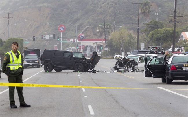 In this Saturday, Feb. 7, 2015 file photo, Los Angeles County Sheriff’s deputy guards the scene of a collision involving three vehicles in Malibu, Calif.