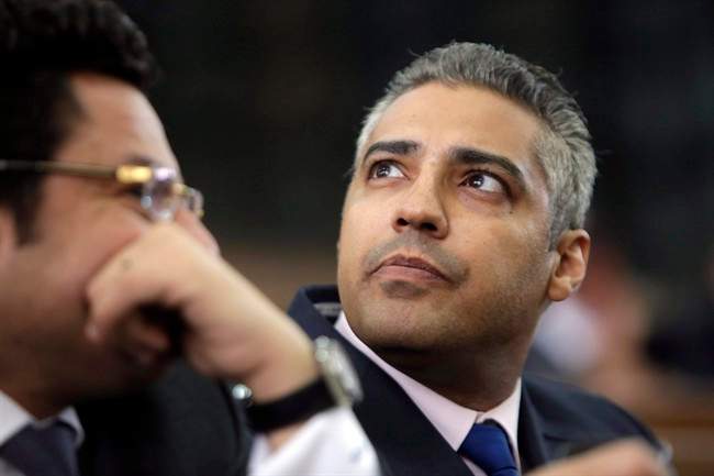 Canadian Al Jazeera English journalist Mohamed Fahmy, right, listens to his lawyer, Khaled Abou Bakr during his retrial in a courtroom, of Tora prison, in Cairo, Egypt, Monday, June 1, 2015. 