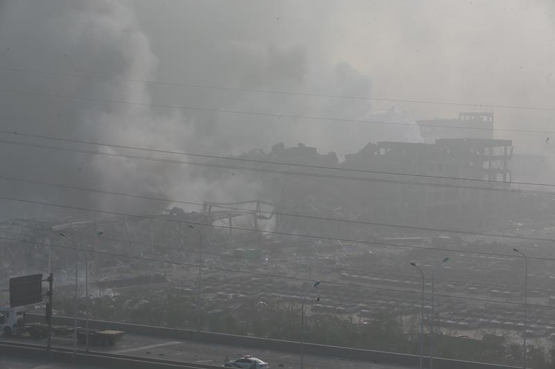 The accident site is still smoking after explosions of a warehouse on late Wednesday in Binhai New Area on August 13, 2015 in Tianjin, China.