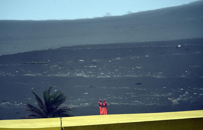 Two coast guards stand guard by the coast near the Wushih harbor in Yilan as typhoon Goni approaches in eastern Taiwan on August 22, 2015.