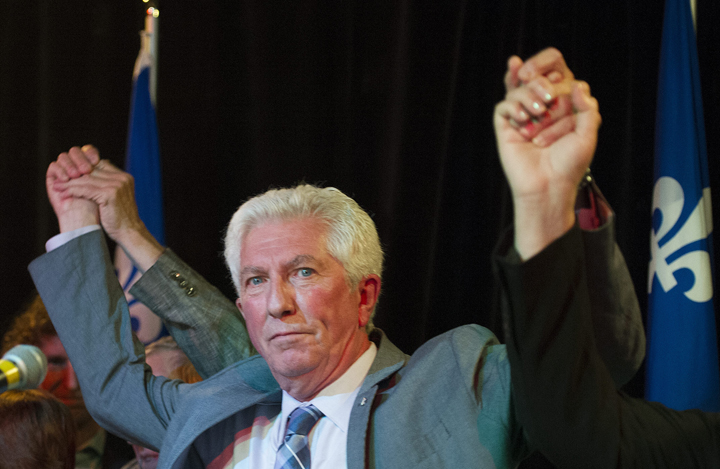 Bloc Quebecois leader Gilles Duceppe has his arms raised by supporters during a federal election campaign stop in Montreal, Friday, August 7, 2015.