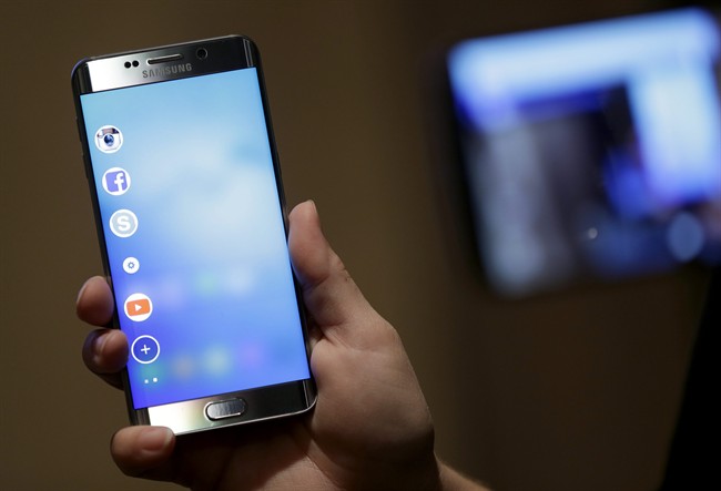 In this Aug. 6. 2015, photo, a Samsung employee displays the new Galaxy S6 Edge Plus in New York.