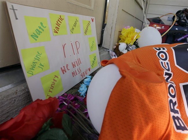 A sign sits against the door Monday, Aug. 10, 2015, as part of the condolences left outside the home where eight people were shot over the weekend in Houston.