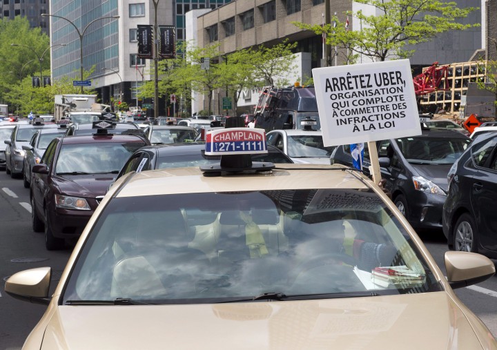 Taxi drivers hold a demonstration through the streets of downtown Montreal against the ride-sharing app Uber, Tuesday, May 19, 2015 in Montreal.