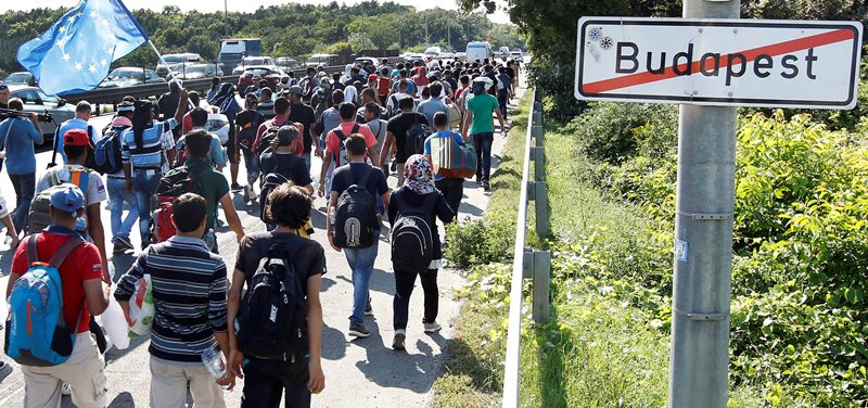 Migrants walk out of Budapest, Hungary, Friday, Sept. 4, 2015. Several thousand migrants left the Keleti railway station in Budapest this afternoon heading for Germany on foot.