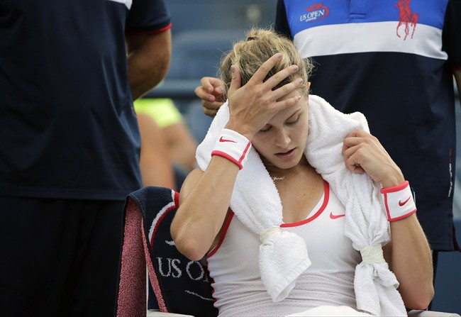 Eugenie Bouchard, of Canada, takes a break between games against Dominika Cibulkova, of Slovakia, during the third round of the U.S. Open tennis tournament, Friday, Sept. 4, 2015, in New York. Bouchard has withdrawn from the U.S. Open with a concussion.