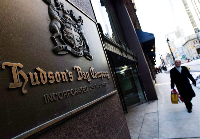 A man walks past the Hudson's Bay Company sign in downtown Toronto.