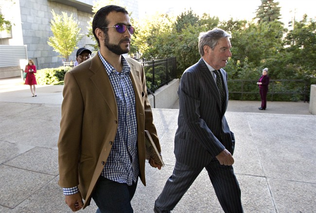 Dennis Edney right, arrives at court hearing in Edmonton, Alta., with Omar Khadr on Friday, September 11, 2015. THE CANADIAN PRESS/Jason Franson