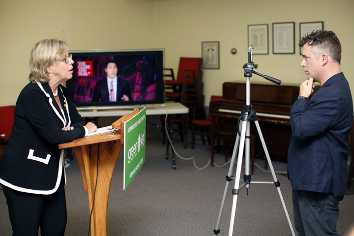 Twitter Canada, Steve Ladurantaye, records Green Party leader Elizabeth May, on his smart phone, to be uploaded to Twitter as she live-tweets to leaders during the Globe and Mail leaders’ debate, in Victoria, B.C., on Thursday, September 17, 2015. The Green party leader wasn’t invited to the Calgary event hosted by the Globe and Mail newspaper, but she’s using Twitter to try to elbow her way into the conversation. THE CANADIAN PRESS/Chad Hipolito