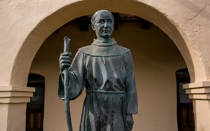 A bronze sculpture of Father Junipero Serra stands at entrance to Mission Santa Ines on December 24, 2014, in Solvang, California.