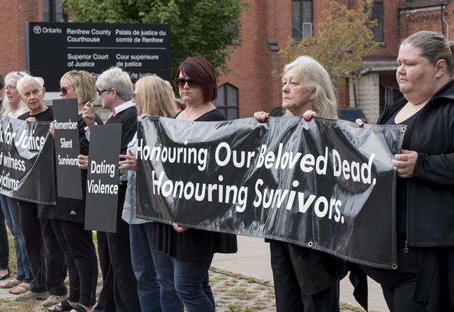 Mourners opposing violence against women stand in solidarity at the courthouse in Pembroke, Ont. on Sept. 23, 2015.