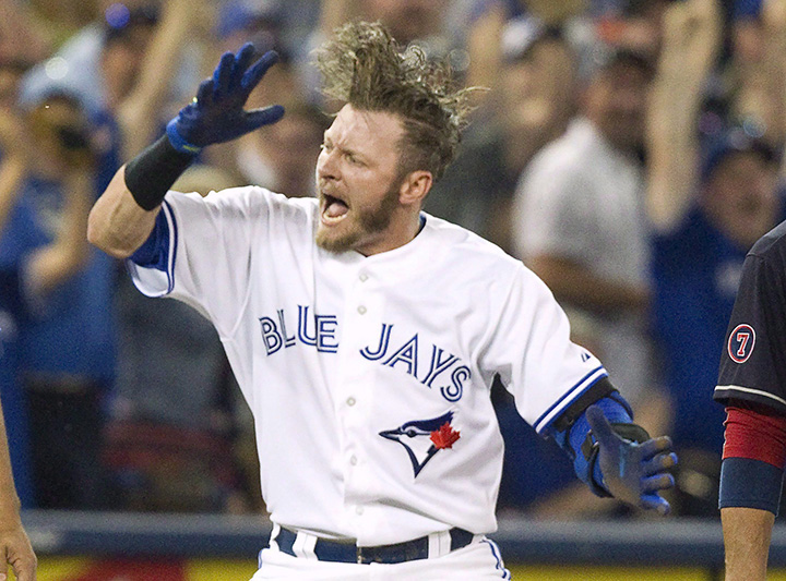 Toronto Blue Jays' Josh Donaldson celebrates after sliding safely into third base with a triple against the Cleveland Indians during fifth inning AL baseball action in Toronto on Monday, August 31, 2015. 
