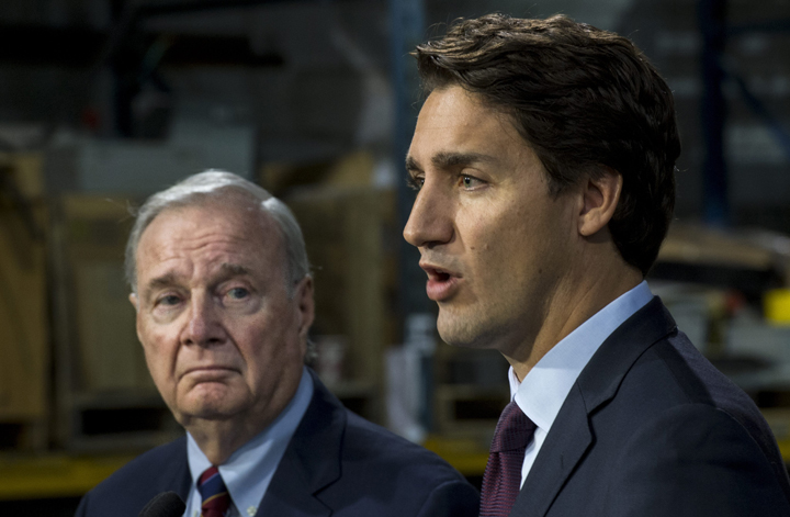 Liberal leader Justin Trudeau addresses supporters next to former prime minister Paul Martin Friday, August 28, 2015 in Montreal. THE CANADIAN PRESS/Paul Chiasson.