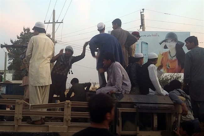 Taliban fighters and young men take over an army truck on a street in Kunduz, north of Kabul, Afghanistan, Monday, Sept. 28, 2015. The Taliban captured the northern Afghan city of Kunduz in a massive assault Monday involving hundreds of fighters, and now control a major urban area for the first time since the 2001 U.S.-led invasion. 