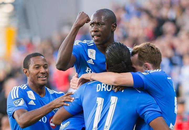Montreal Impact's Didier Drogba (11) celebrates with teammates, from left, Patrice Bernier, Hassoun Camara and Wandrille Lefevre after scoring against D.C. United during first half MLS soccer action in Montreal, Sept. 26, 2015. 