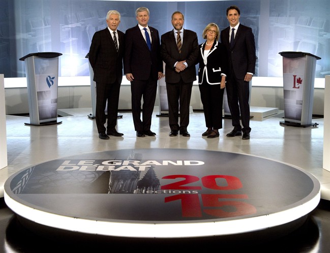 Bloc Quebecois Leader Gilles Duceppe, from left to right, Conservative Leader Stephen Harper, NDP Leader Tom Mulcair, Green party Leader Elizabeth May and Liberal Leader Justin Trudeau pose for photos before the French-language leaders' debate Thursday, September 24, 2015, in Montreal.