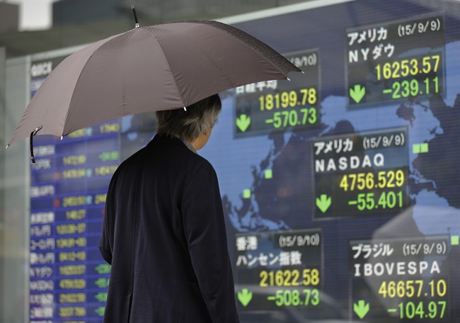 A man looks at an electronic stock indicator of a securities.