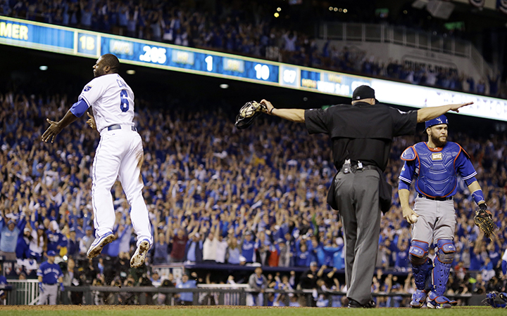 Kansas City Royals' Lorenzo Cain is safe at home past Toronto Blue Jays catcher Russell Martin on a hit by Eric Hosmer during the eight inning in Game 6 of baseball's American League Championship Series on Friday, Oct. 23, 2015, in Kansas City, Mo.