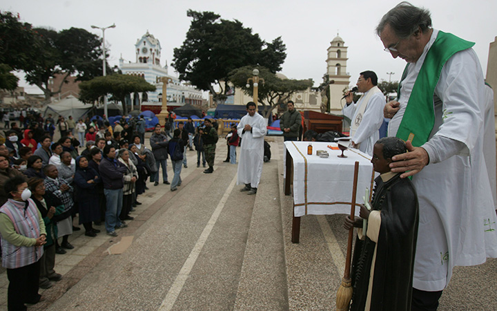 A Catholic priest at mass in the main square in Pisco, Peru.