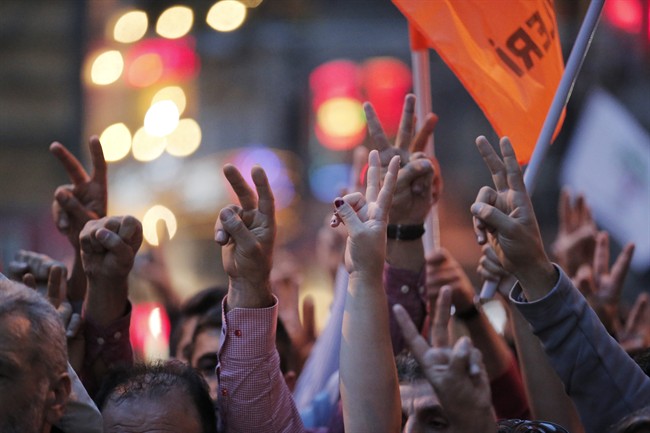 Demonstrators flash the V-sign during a rally to protest against the bombing in Ankara earlier, in central Istanbul, Saturday, Oct. 10, 2015. Thousands of protestors flooded the main street in central Istanbul shouting slogans condemning the twin bombings that killed dozens of people in nation¹s capital. The two bomb explosions targeted a peace rally, that was aimed to call for an end to the renewed violence between Kurdish rebels and Turkish security forces.