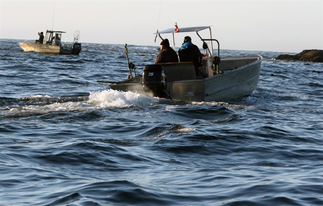 Ahousaht First Nation boats patrol an area near where the whale watching boat Leviathan II sank near Tofino, British Columbia, Monday, Oct. 26, 2015.  