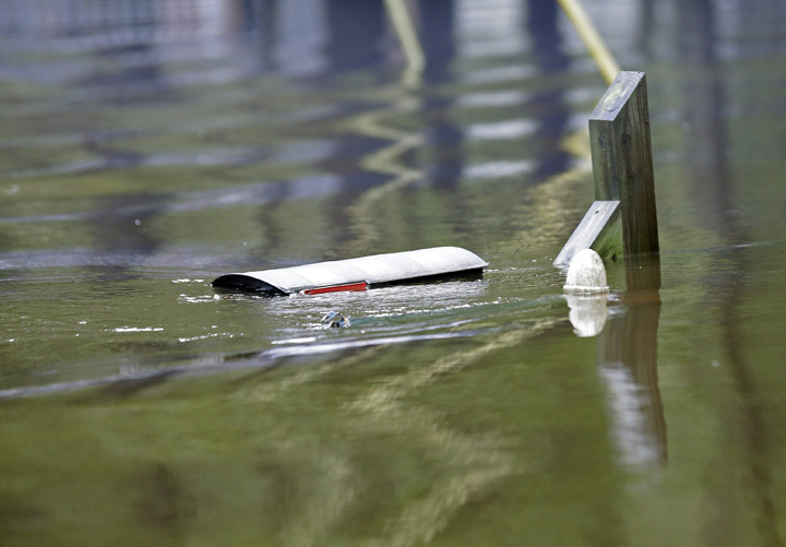 A mailbox is nearly submerged in floodwater in a neighborhood near the overflowing Black Creek in Florence, S.C., Monday, Oct. 5, 2015.