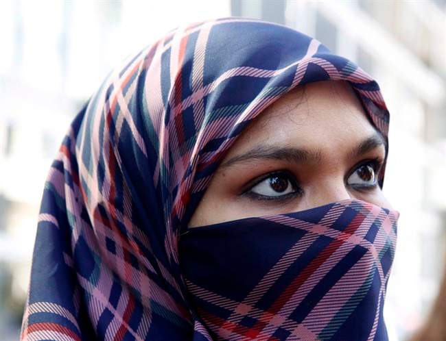A woman wears a niqab.
