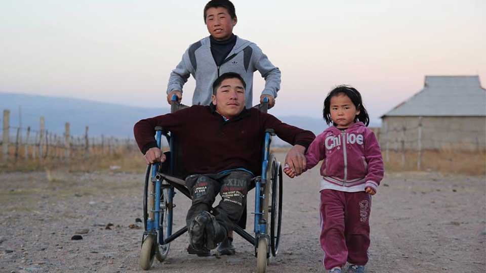 Nurgazy, the oldest of three siblings, is pushed to school every day by his younger brother Dastan.
