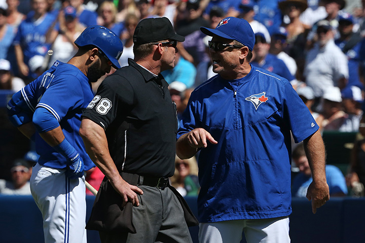 Home plate umpire Jim Wolf listens to objections from manager John Gibbons of the Toronto Blue Jays after ejecting him in the seventh inning against the Kansas City Royals during MLB game action on August 2, 2015 at Rogers Centre in Toronto.