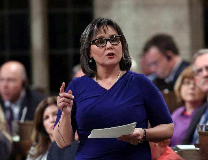 Environment Minster Leona Aglukkaq stands in the House of Commons during question period on Parliament Hill in Ottawa.