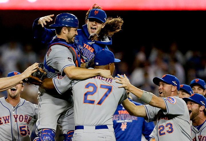 New York Mets starting pitcher Jacob deGrom, above right, catcher Travis d’Arnaud, left, and other Mets players celebrate a 3-2 win over the Los Angeles Dodgers in Game 5 of baseball’s National League Division Series on Thursday, Oct. 15, 2015, in Los Angeles.