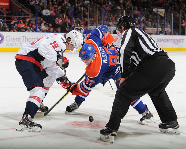 Connor McDavid #97 of the Edmonton Oilers takes a face off against Nicklas Backstrom #19 of the Washington Capitals on October 23, 2015 at Rexall Place in Edmonton, Alberta, Canada.