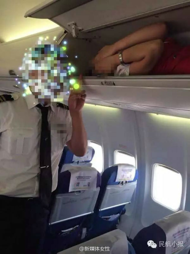 One of the photos posted to the Civil Aviation Tabloid account on Weibo purportedly showing a Kunming Airlines flight attendant in the overhead baggage compartment as another crew member poses for the photograph.