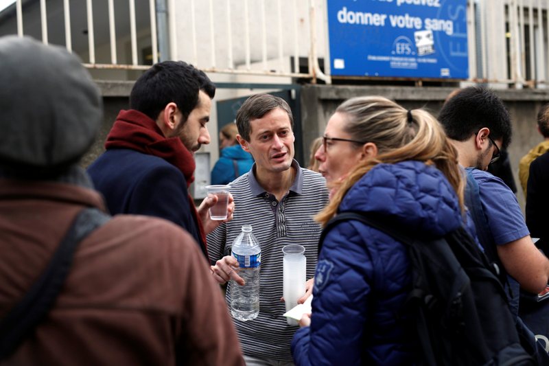 People line up to give blood at the St Louis hospital across the street from the Petit Cambodge restaurant in Paris Saturday Nov. 14, 2015, a day after over 120 people were killed in a series of shooting and explosions.