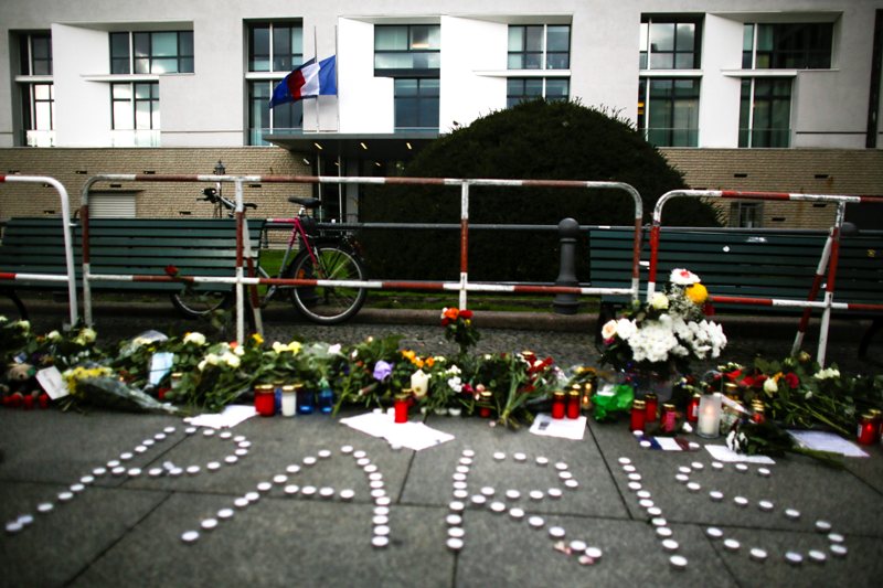 People have placed flowers and candles to mourn for the victims killed in the Friday’s attacks in Paris, France, in front of the French Embassy in Berlin, Saturday, Nov. 14, 2015.