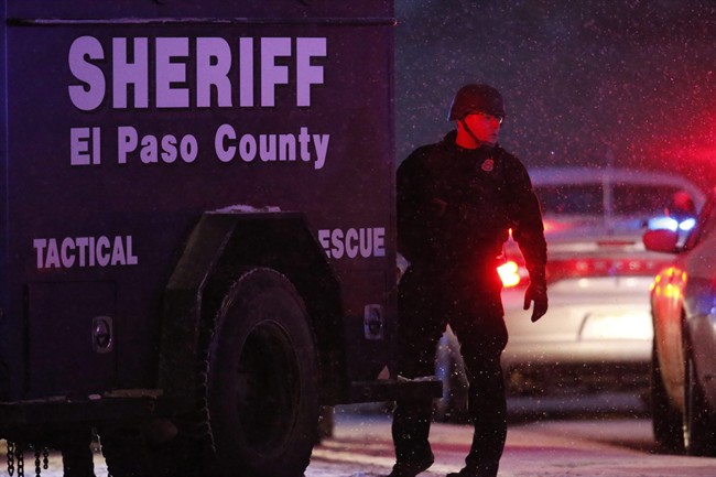 Police stand guard after a suspect was apprehended Friday, Nov. 27, 2015, in northwest Colorado Springs, Colo. A gunman opened fire at a Planned Parenthood clinic on Friday, authorities said, wounding multiple people. 