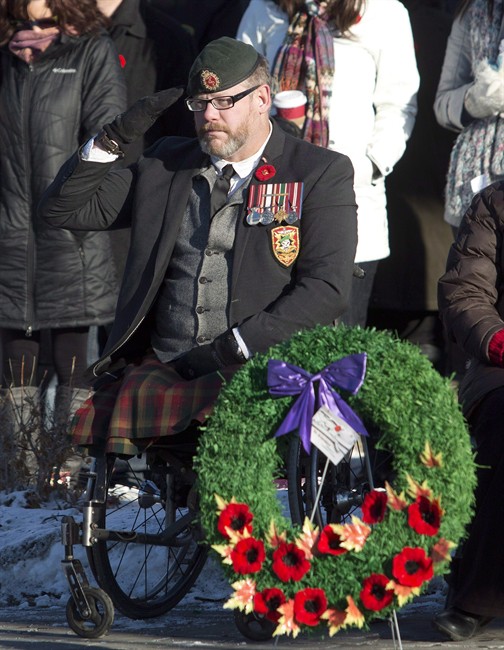 Veteran Paul Franklin, who lost both his legs in a suicide bombing in Kandahar, is shown saluting during the First Battalion Princess Patricia's Canadian Light Infantry Remembrance Day ceremony in Edmonton, Alberta, on Monday, November 11, 2013.