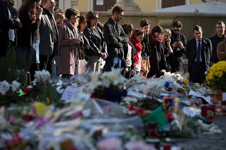 People mourn in front of the French Embassy, in Rome on Nov. 16, 2015 during a Europe-wide minute of silence to honour the victims of the terror attacks in Paris.