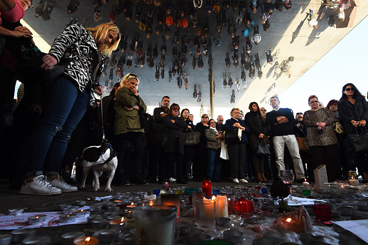 People observe a minute of silence on November 16, 2015 on the old Harbour in Marseille to pay tribute to victims of the attacks in Paris.