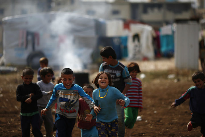 Syrian refugees play at a refugee camp in the town of Hosh Hareem, in the Bekaa valley, east Lebanon, Wednesday, October 28, 2015.