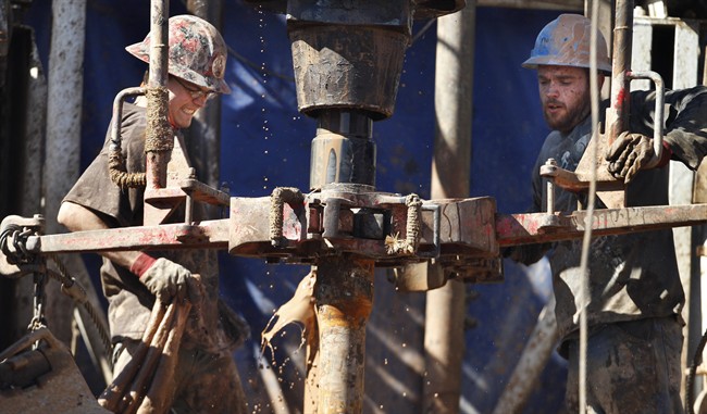 Feb. 21, 2012 file photo of oil field workers  using a drill.